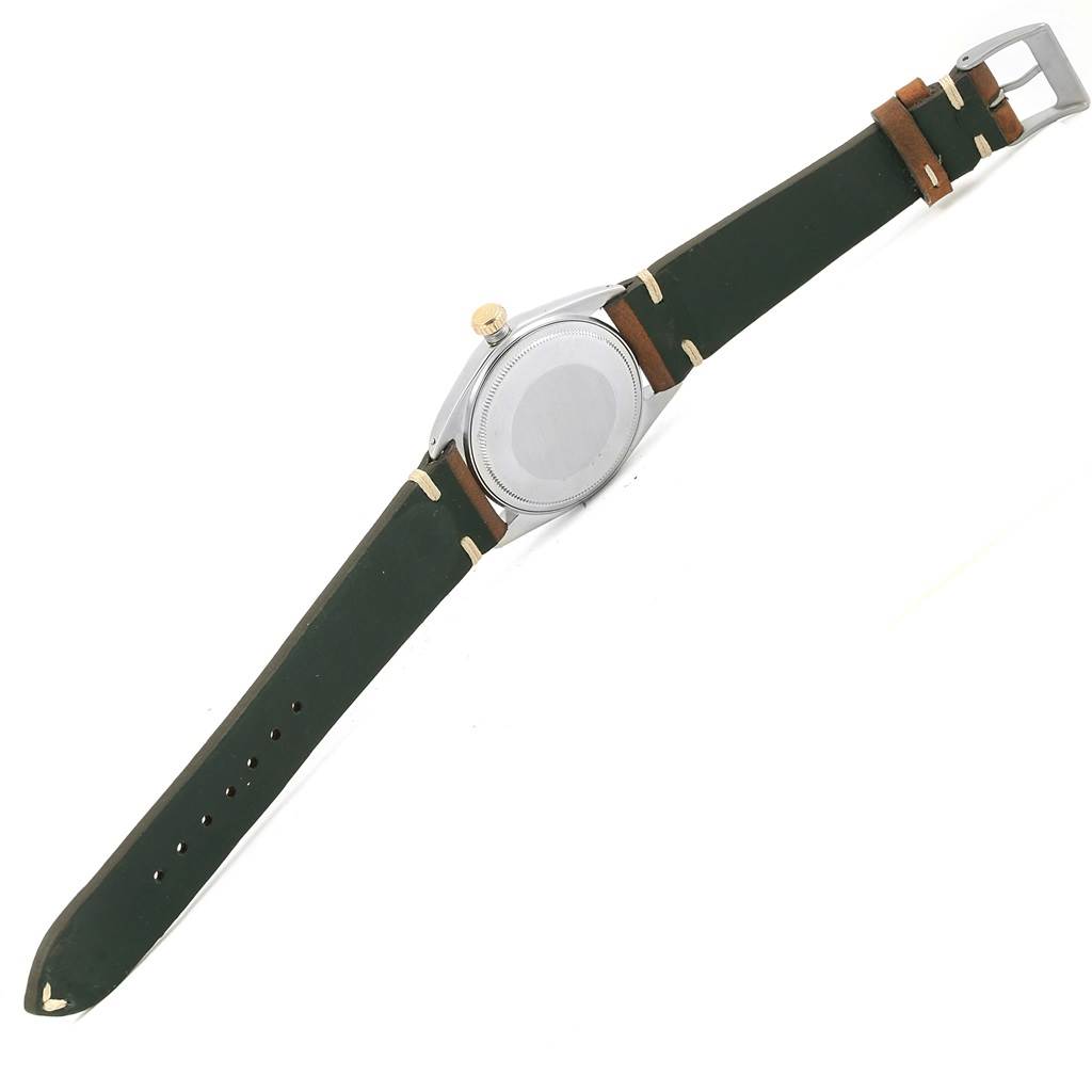 This image shows the back and strap of a Vintage Collection model by Rolex, displayed from an overhead angle.