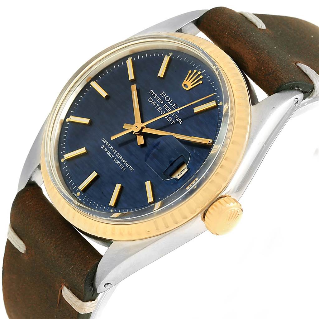 This is a close-up angle of the Rolex Vintage Collection 1601 Men's Steel and Gold (two tone) Blue Dial 1601 Men's Steel and Gold (two tone) Blue Dial watch showing the face, bezel, crown, and leather strap.