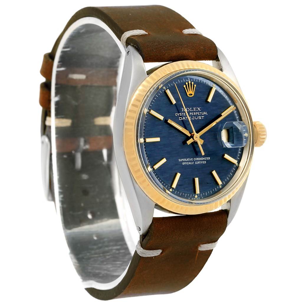 The image shows a Rolex Vintage Collection 1601 Men's Steel and Gold (two tone) Blue Dial 1601 Men's Steel and Gold (two tone) Blue Dial watch featuring a round face with a blue dial, gold bezel, and leather strap at an angle.