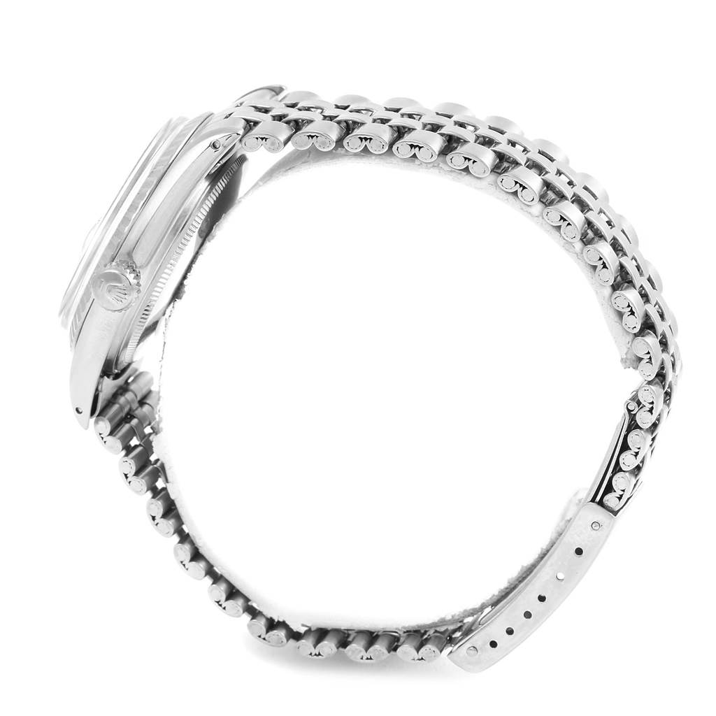 The image shows the side view of a Rolex Vintage Collection 1603 Men's Stainless Steel Silver Dial 1603 Men's Stainless Steel Silver Dial watch, highlighting its bracelet, case, and crown.