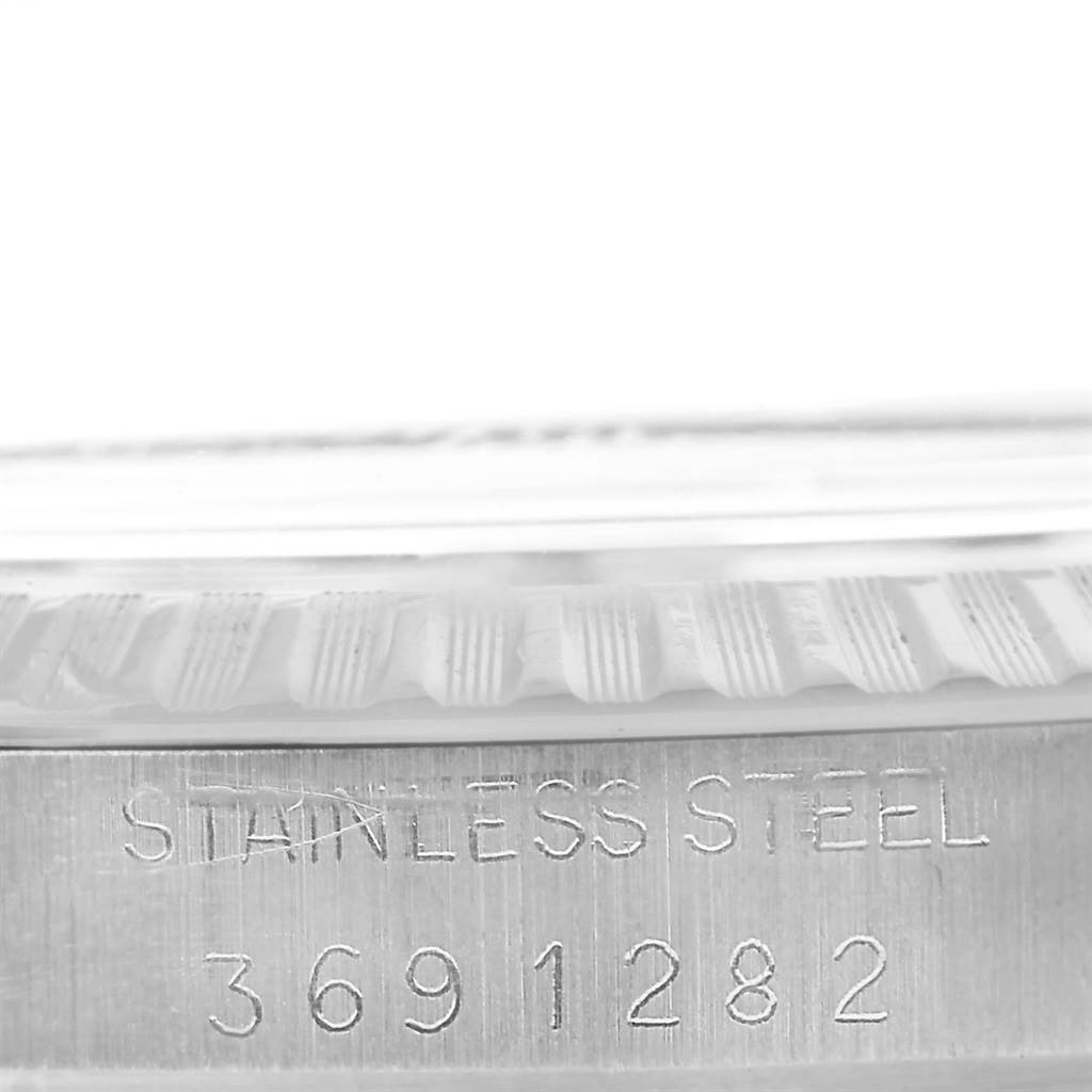 The image shows a close-up of the side of a Vintage Collection Rolex watch, highlighting the stainless steel inscription and serial number.