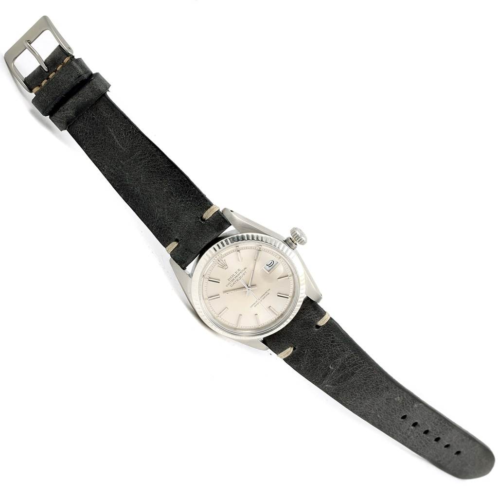 The Rolex Vintage Collection 1601 Men's Stainless Steel Silver Dial 1601 Men's Stainless Steel Silver Dial watch is shown from a top-down angle, displaying its face, case, and black leather strap.