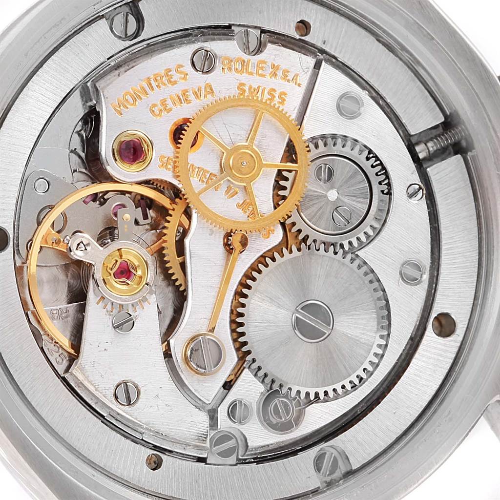 The image shows the inner mechanical movement parts, including gears and springs, of a Rolex Vintage Collection 6694 Men's Stainless Steel Silver Dial 6694 Men's Stainless Steel Silver Dial watch.