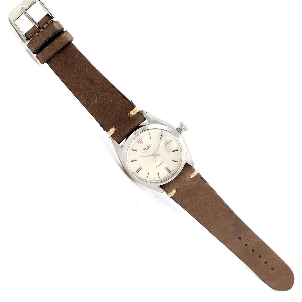 The image shows a Rolex Vintage Collection 6694 Men's Stainless Steel Silver Dial 6694 Men's Stainless Steel Silver Dial watch from a top-down angle, featuring its brown leather strap and silver watch face.