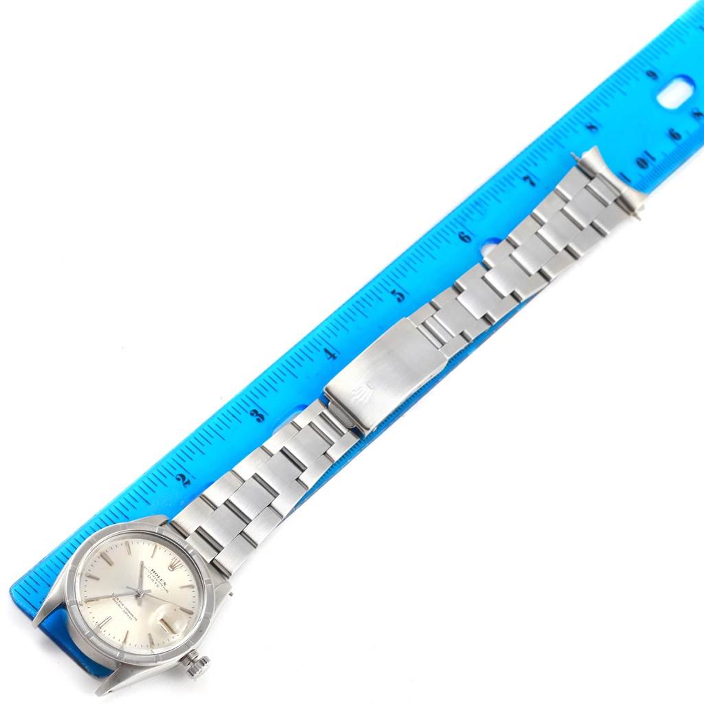 The image shows a Rolex Vintage Collection 1501 Men's Stainless Steel Silver Dial 1501 Men's Stainless Steel Silver Dial watch laid flat with its full bracelet and clasp, alongside a blue ruler for size reference.