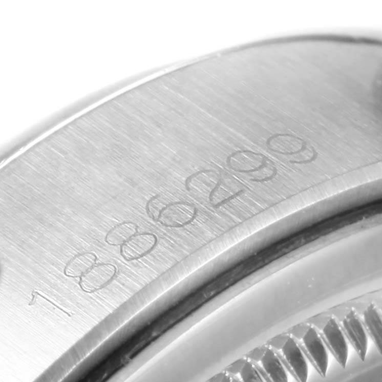 This close-up image shows part of the casing and serial number engraving of a Rolex Vintage Collection 6694 Men's Stainless Steel Blue Dial 6694 Men's Stainless Steel Blue Dial watch.