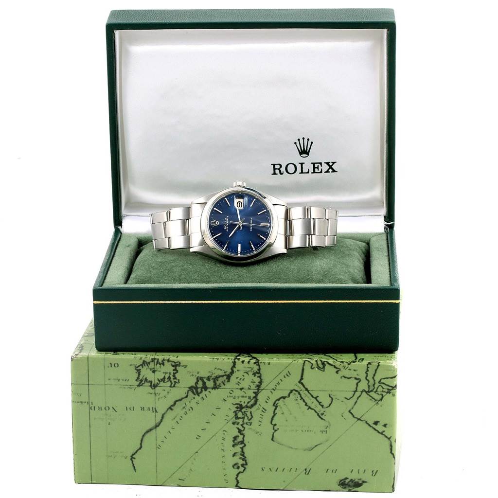 The Rolex Vintage Collection 6694 Men's Stainless Steel Blue Dial 6694 Men's Stainless Steel Blue Dial watch is displayed front and center in its open green box with a blue dial and stainless steel bracelet.