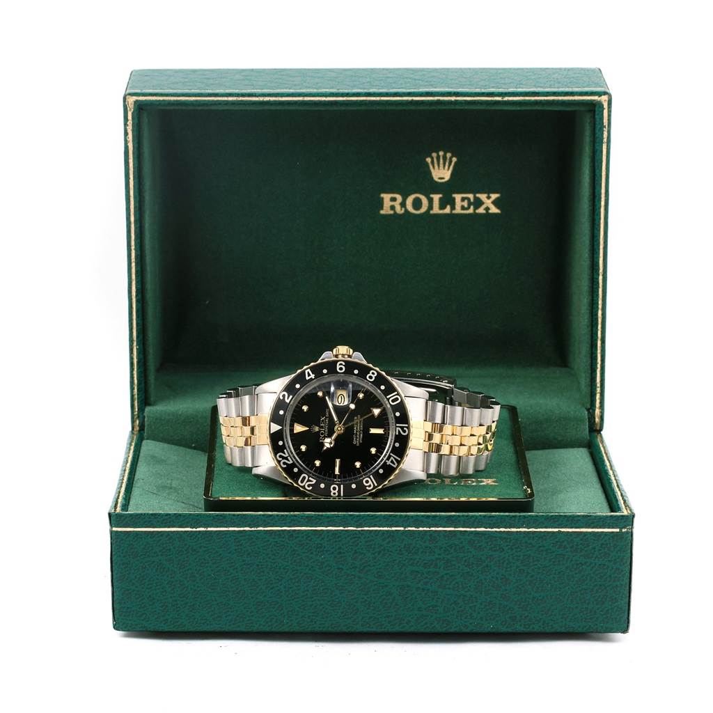The Vintage Collection Rolex watch is shown from the front, displayed in an open Rolex box with a two-tone bracelet and black dial.