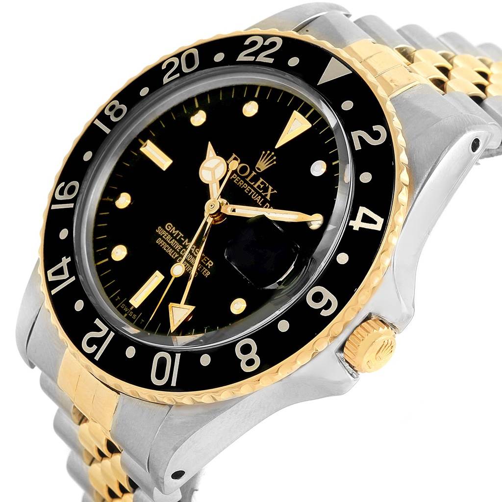 The image shows a close-up angle of the face, bezel, and part of the bracelet of the Rolex GMT-Master Vintage Collection watch.