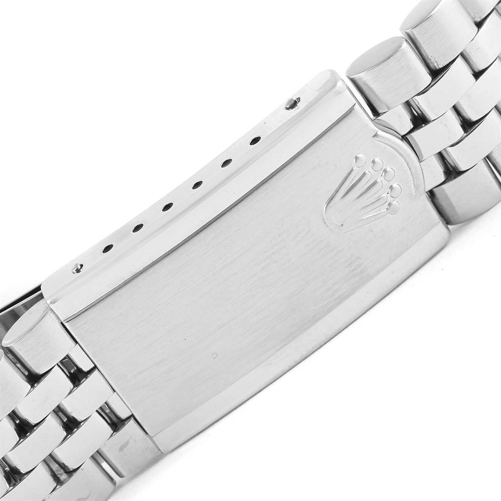 The image shows a close-up of the clasp of a Rolex Vintage Collection 1603 Men's Stainless Steel Silver Dial 1603 Men's Stainless Steel Silver Dial watch bracelet with the Rolex logo engraved.