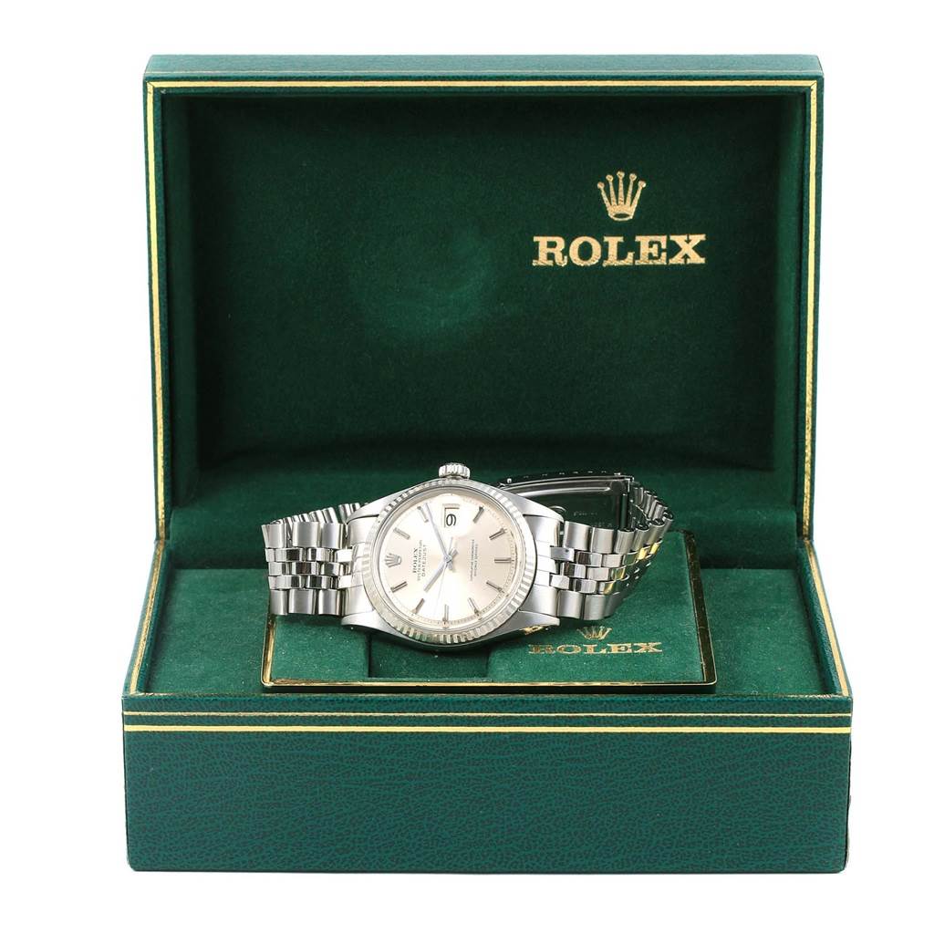 The Vintage Collection Rolex watch is shown from the front, inside its branded green box with its bracelet visible.