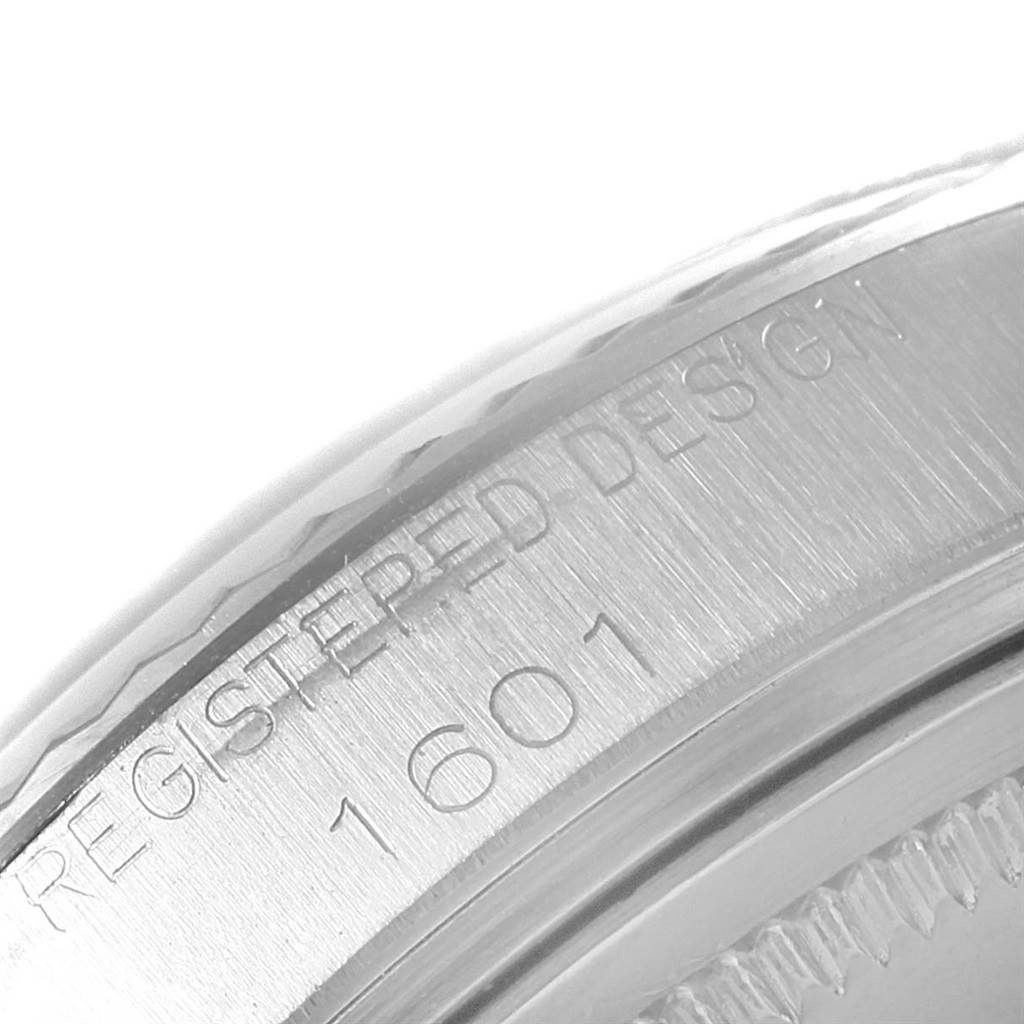 This image shows a close-up of the case side of a Rolex Vintage Collection 1601 Men's Stainless Steel Silver Dial 1601 Men's Stainless Steel Silver Dial model 1601, highlighting the engraved text.