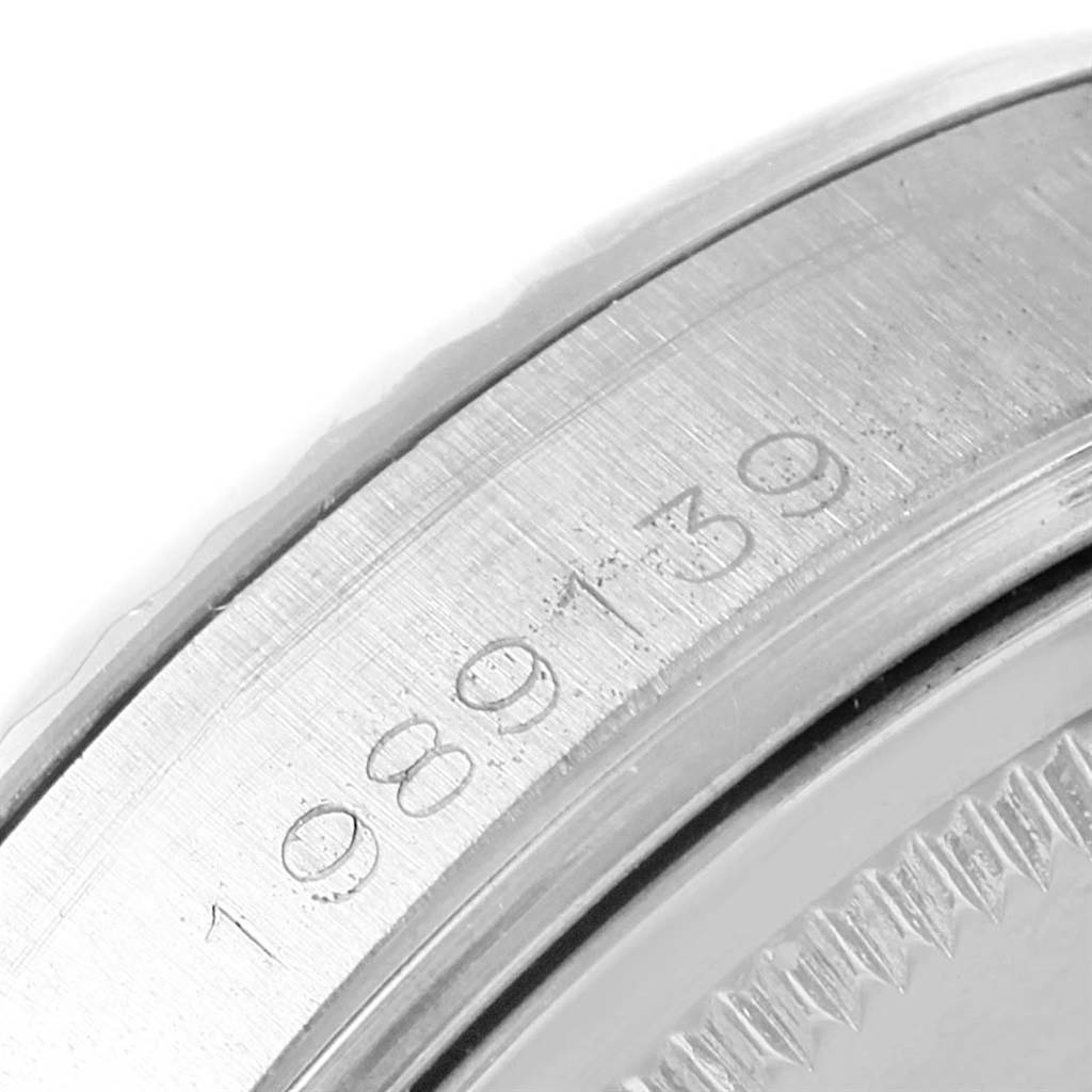 This image shows a close-up of the serial number on the edge of a Rolex Vintage Collection 1601 Men's Stainless Steel Silver Dial 1601 Men's Stainless Steel Silver Dial watch case.
