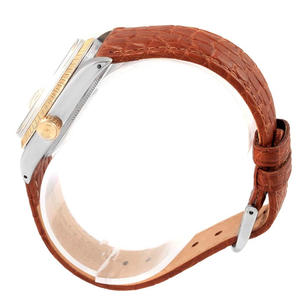 This image shows a side view of the Rolex Vintage Collection 1505 Men's Stainless Steel Champagne Dial 1505 Men's Stainless Steel Champagne Dial watch, highlighting its case, crown, bezel, and brown leather strap.