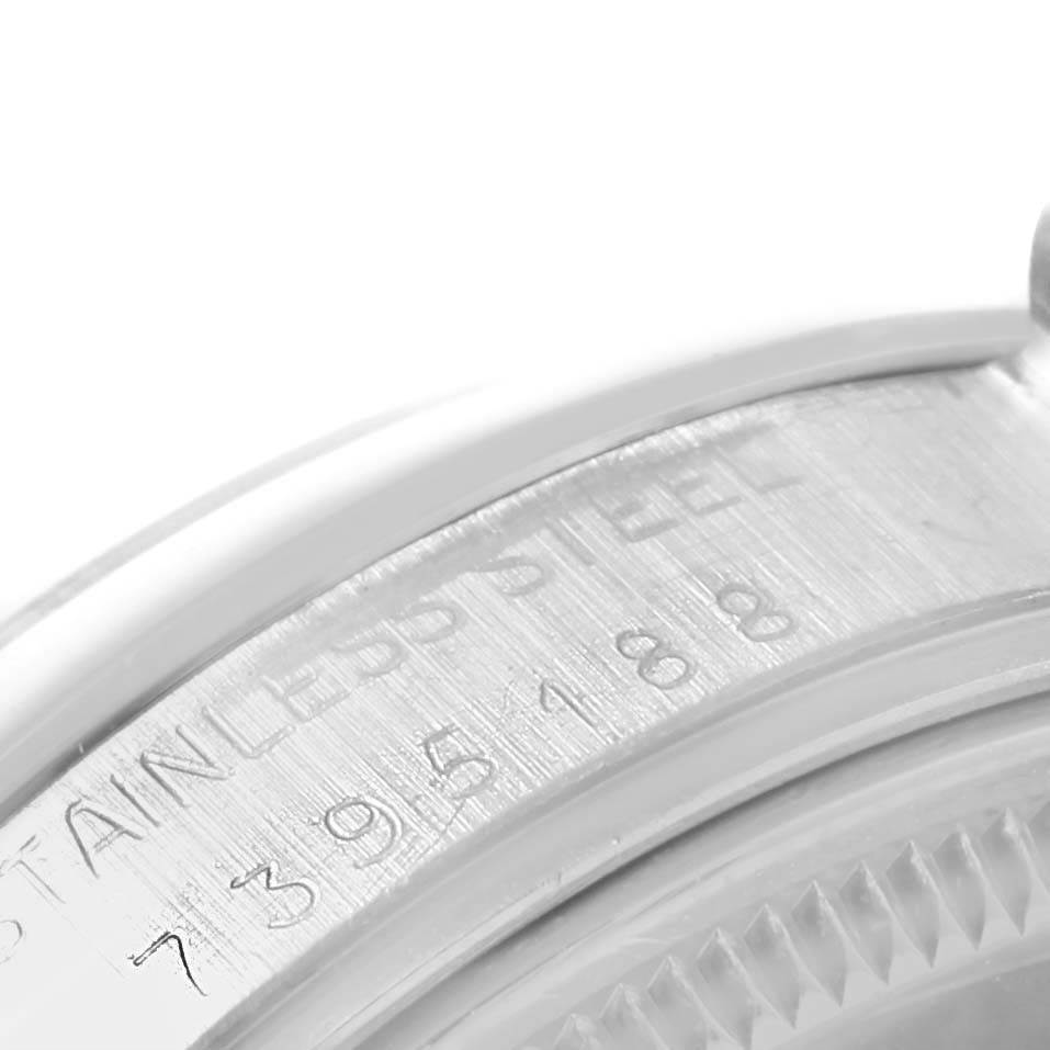 This image shows a close-up of the serial number and "Stainless Steel" engraving on the case back of a Vintage Collection Rolex watch.