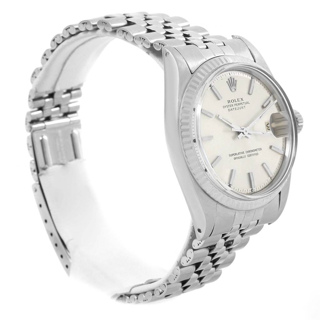 The Vintage Collection Rolex watch is shown from a three-quarter angle, highlighting the white dial, bezel, and metal bracelet.