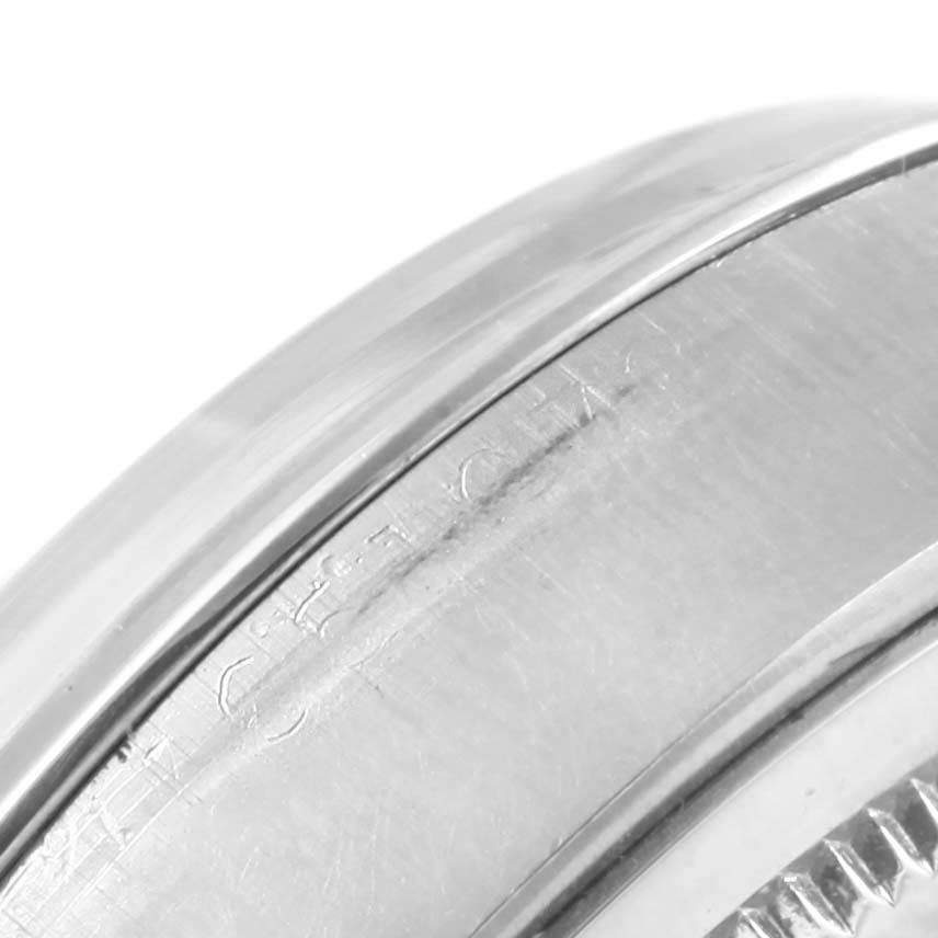 The image shows a close-up of the side of the bezel and case of the Rolex Vintage Collection 6694 Men's Stainless Steel Black Dial 6694 Men's Stainless Steel Black Dial model watch, highlighting its polished surface.