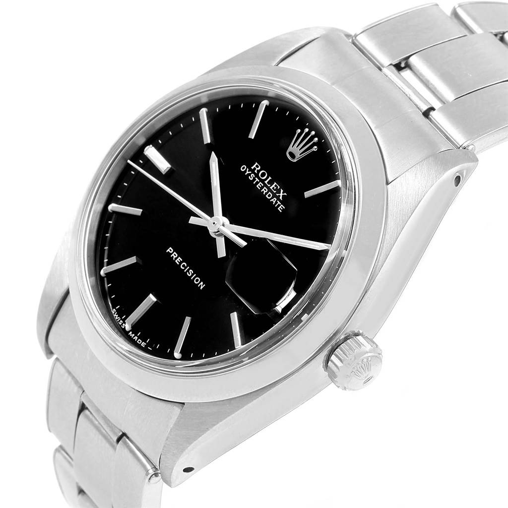 The image shows a close-up, side-angle view of a Rolex Vintage Collection 6694 Men's Stainless Steel Black Dial 6694 Men's Stainless Steel Black Dial Oysterdate watch, highlighting the black dial and metal bracelet.