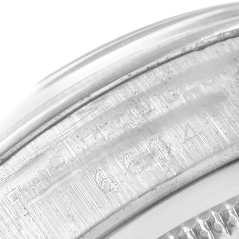 This is a close-up angle of the side of the bezel or the inner ring of a Rolex Vintage Collection 6694 Men's Stainless Steel Black Dial 6694 Men's Stainless Steel Black Dial watch, showing engraved details.