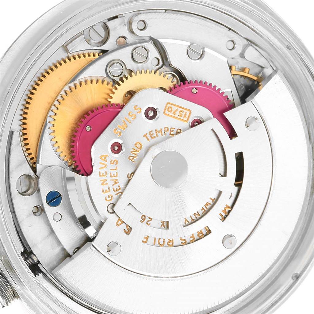The image shows the internal mechanism and gears of a Vintage Collection Rolex watch.