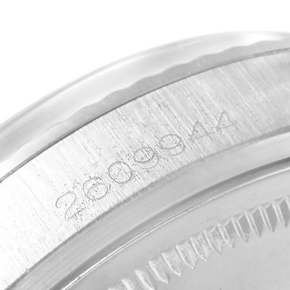 This image shows a close-up of the case side, serial number, and bezel of the Rolex Vintage Collection 1601 Men's Stainless Steel Silver Dial 1601 Men's Stainless Steel Silver Dial model watch.