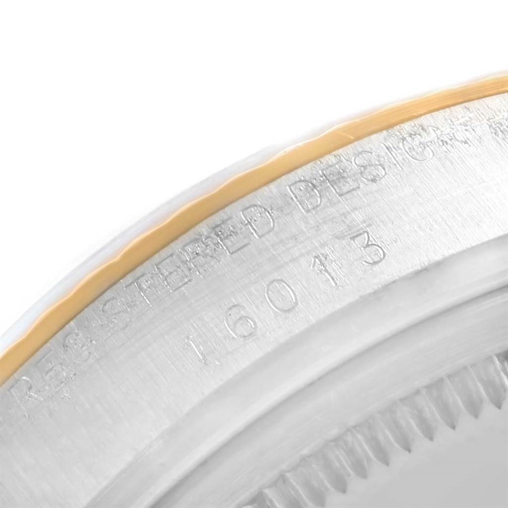 This image shows a close-up of the engraved side of a Vintage Collection watch by Rolex, including the serial number and part of the bezel.