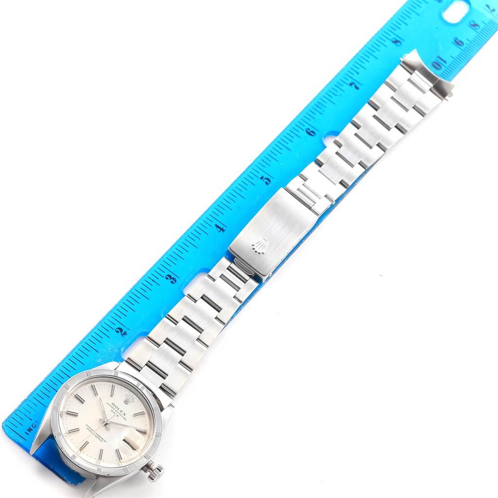 The Rolex Vintage Collection 1501 Men's Stainless Steel Silver Dial 1501 Men's Stainless Steel Silver Dial watch is displayed flat, showing the face, bracelet, and clasp against a ruler for size reference.