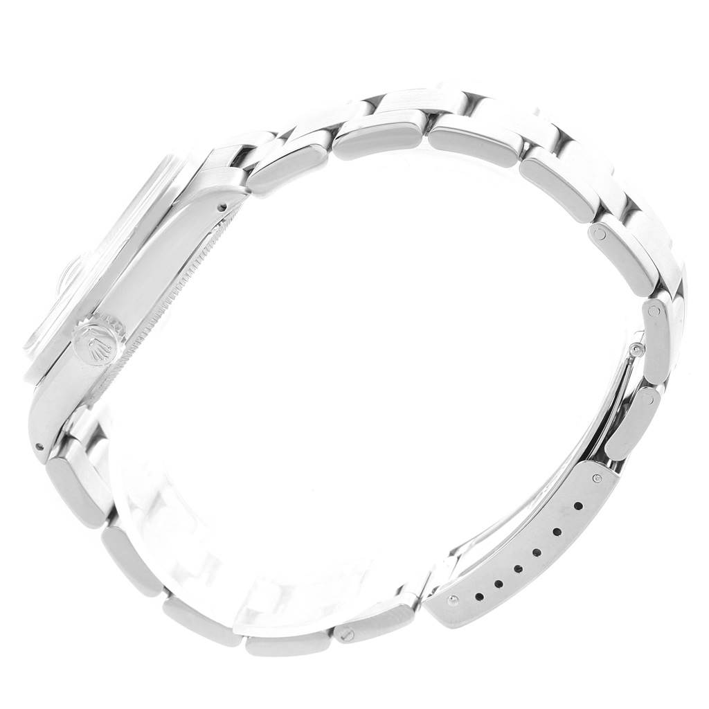 The Vintage Collection Rolex watch is shown from a side angle, highlighting the crown, case, and a partial view of the bracelet.