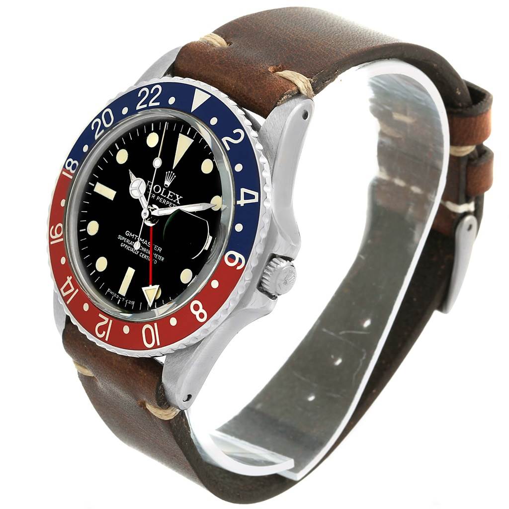 This image shows a Rolex Vintage Collection 1675 Men's Stainless Steel Black Dial 1675 Men's Stainless Steel Black Dial GMT-Master watch from a three-quarter angle, highlighting the bezel, face, and leather strap.