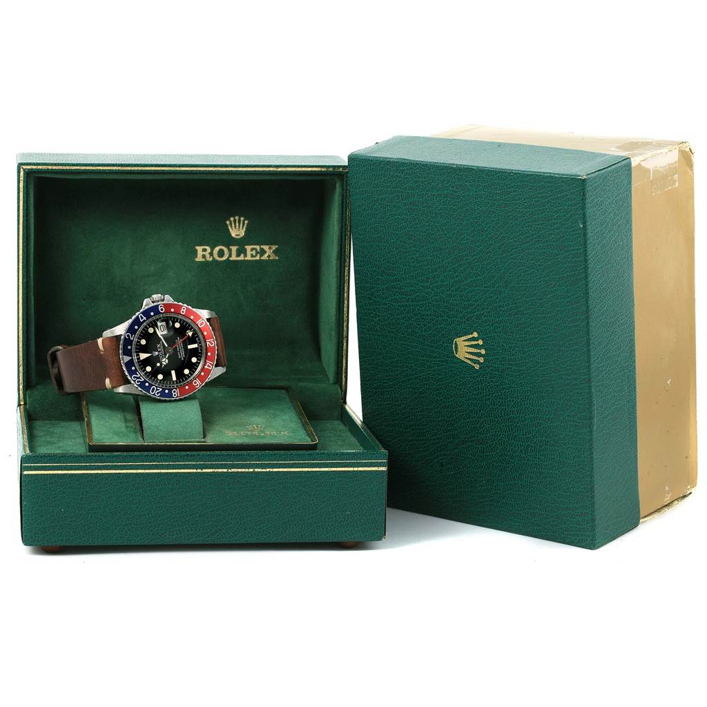 The Rolex Vintage Collection 1675 Men's Stainless Steel Black Dial 1675 Men's Stainless Steel Black Dial watch is shown at a front angle, nestled in its green box with the cover open, displaying its band and dial.