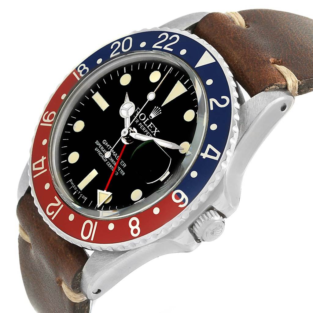 The image shows a Vintage Collection Rolex GMT-Master watch at an angled view, highlighting the bezel, dial, crown, and leather strap.