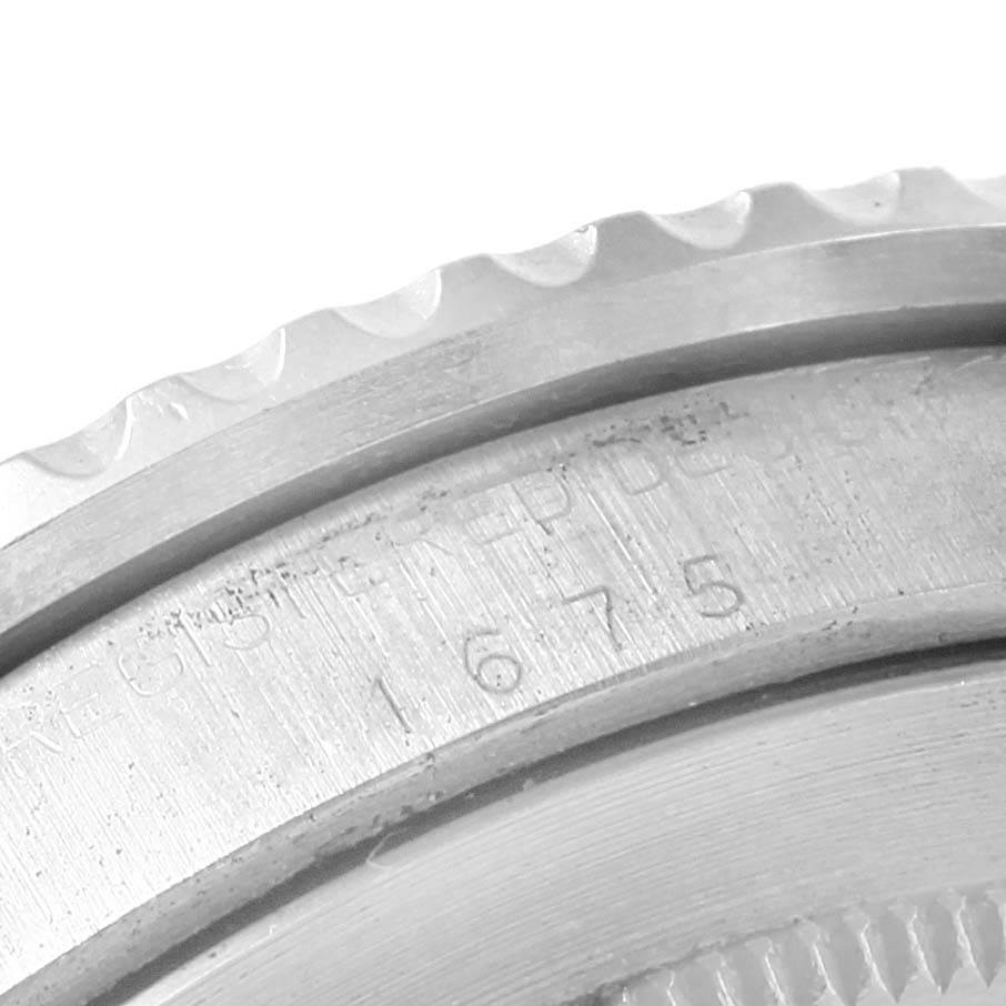 This image shows a close-up of the case back and edge of the bezel of a Rolex Vintage Collection 1675 Men's Stainless Steel Black Dial 1675 Men's Stainless Steel Black Dial watch.