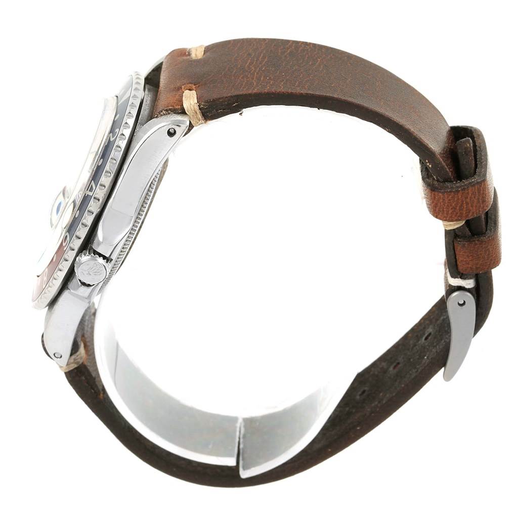 The watch is shown from the side, displaying the Rolex Vintage Collection 1675 Men's Stainless Steel Black Dial 1675 Men's Stainless Steel Black Dial model's case, crown, and leather strap.