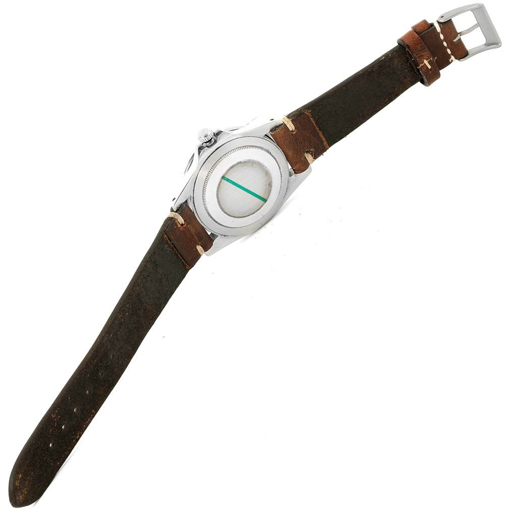 The Vintage Collection Rolex watch is shown from the back, highlighting its case and leather strap.