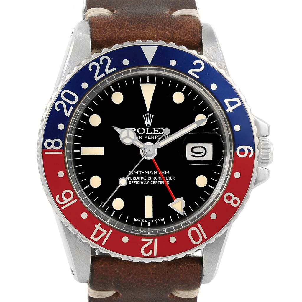 The Vintage Collection Rolex GMT-Master watch is shown from the front, highlighting its bezel, dial, and leather strap.