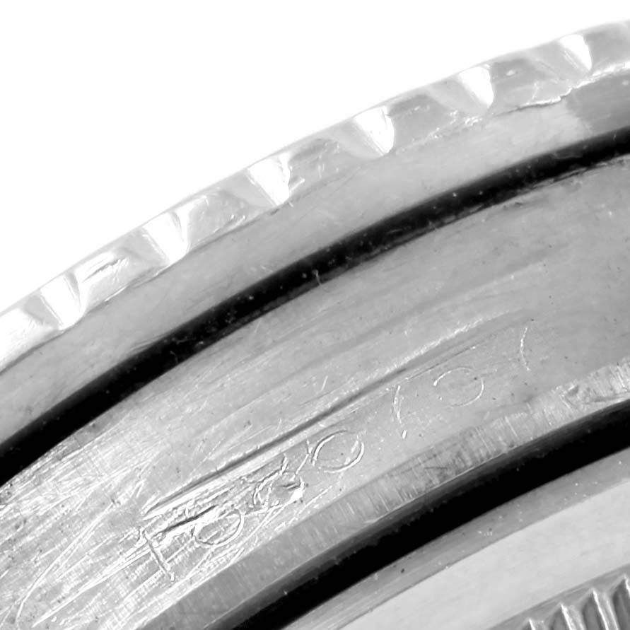 This image shows a close-up view of the engraved bezel and part of the casing of a Rolex Vintage Collection 1675 Men's Stainless Steel Black Dial 1675 Men's Stainless Steel Black Dial watch.