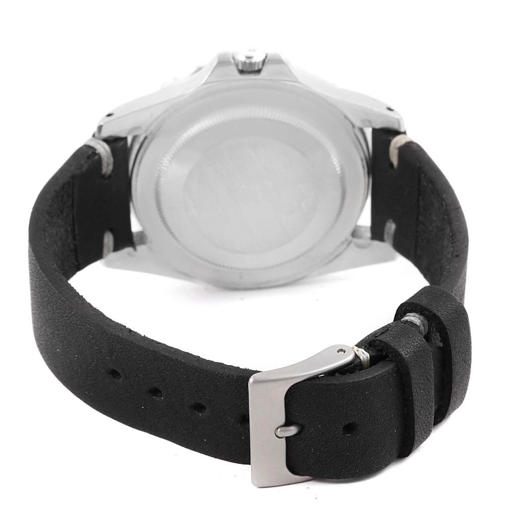 The image shows the back view of a Rolex Vintage Collection 1675 Men's Stainless Steel Black Dial 1675 Men's Stainless Steel Black Dial watch, highlighting its case back and black leather strap with buckle.