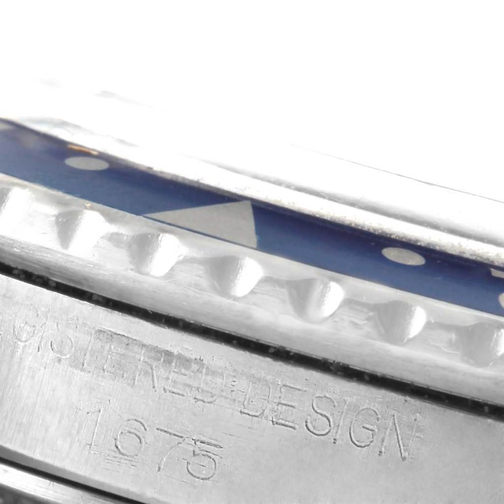 The image shows a close-up of the bezel and engraved case side of the Rolex Vintage Collection 1675 Men's Stainless Steel Black Dial 1675 Men's Stainless Steel Black Dial model 1675 watch.