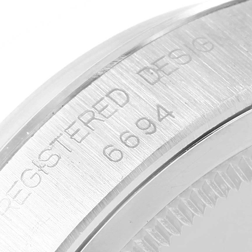 This image shows a close-up of the side of a Vintage Collection Rolex watch, featuring the engraved model number 6694.