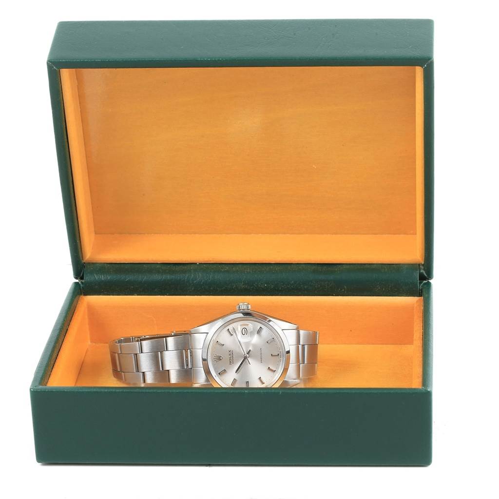 A Rolex Vintage Collection 6694 Men's Stainless Steel Silver Dial 6694 Men's Stainless Steel Silver Dial watch is shown from the front inside an open green and orange box.