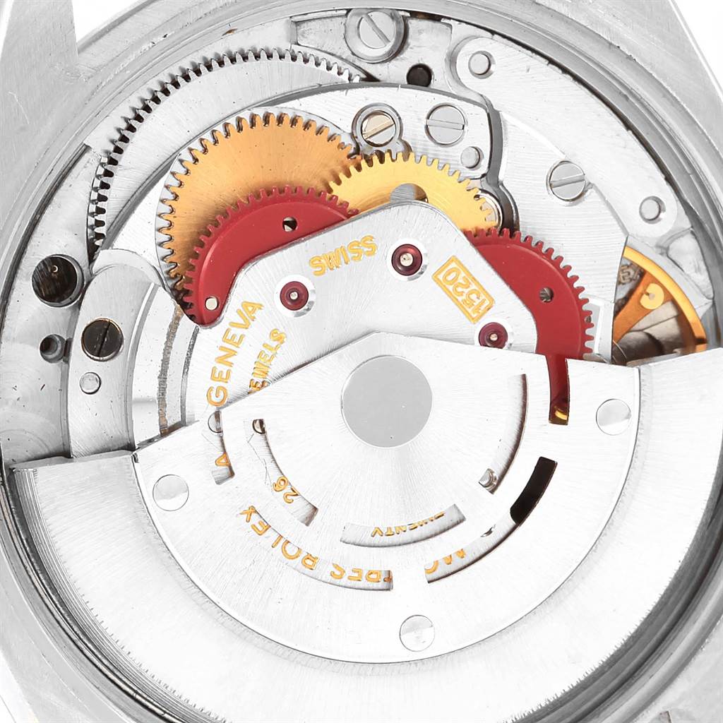 The image shows an internal view of the Vintage Collection Rolex watch's movement mechanism with visible gears and components.