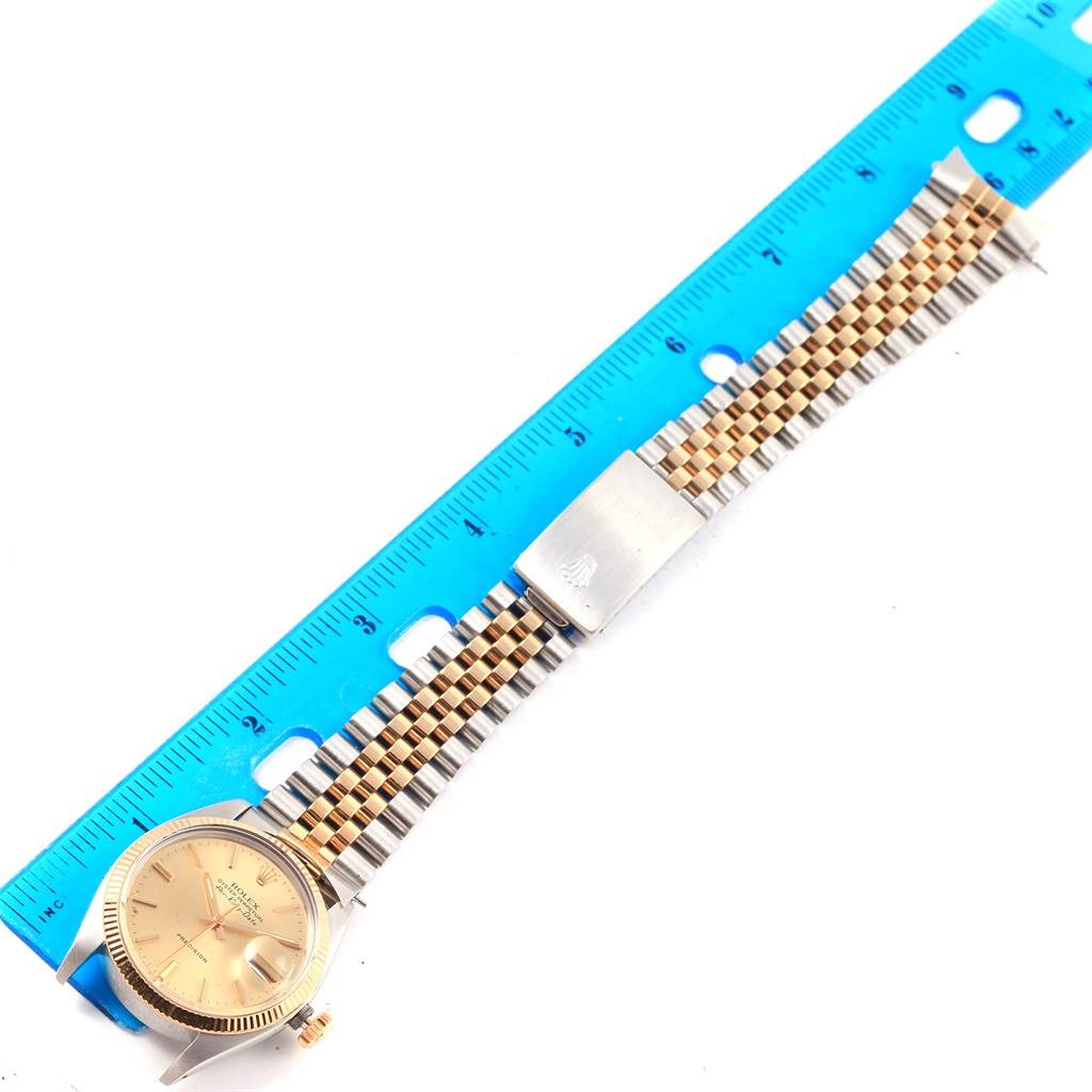 The image shows the front view of a Rolex Vintage Collection 5701 Men's Steel and Gold (two tone) Champagne Dial 5701 Men's Steel and Gold (two tone) Champagne Dial watch, including the face, bezel, case, and a portion of the watch band.