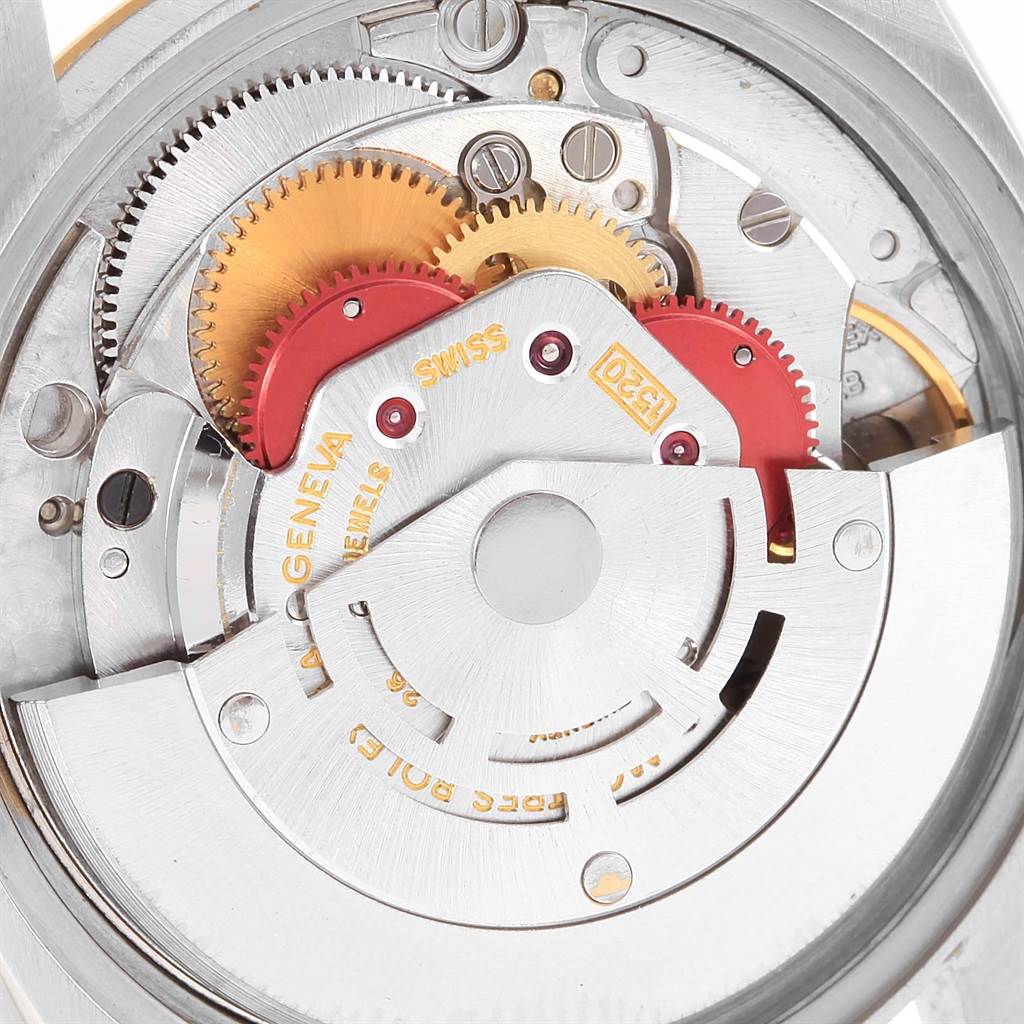 This close-up image shows the intricate internal mechanism of a Rolex Vintage Collection 5701 Men's Steel and Gold (two tone) Champagne Dial 5701 Men's Steel and Gold (two tone) Champagne Dial watch, highlighting gears and components.