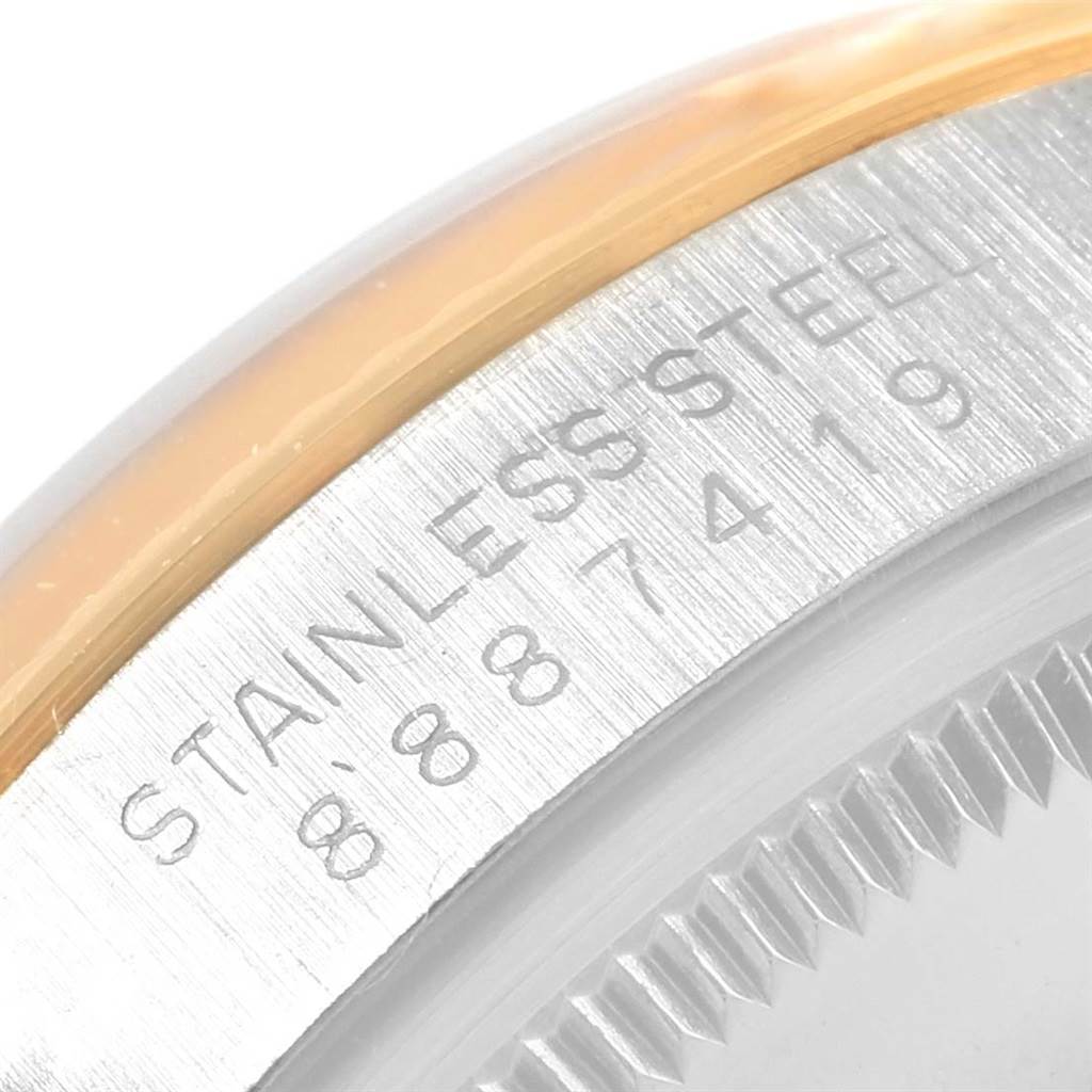 The image shows a close-up of the bezel and case edge of the Rolex Vintage Collection 5701 Men's Steel and Gold (two tone) Champagne Dial 5701 Men's Steel and Gold (two tone) Champagne Dial watch with "STAINLESS STEEL" engraved.