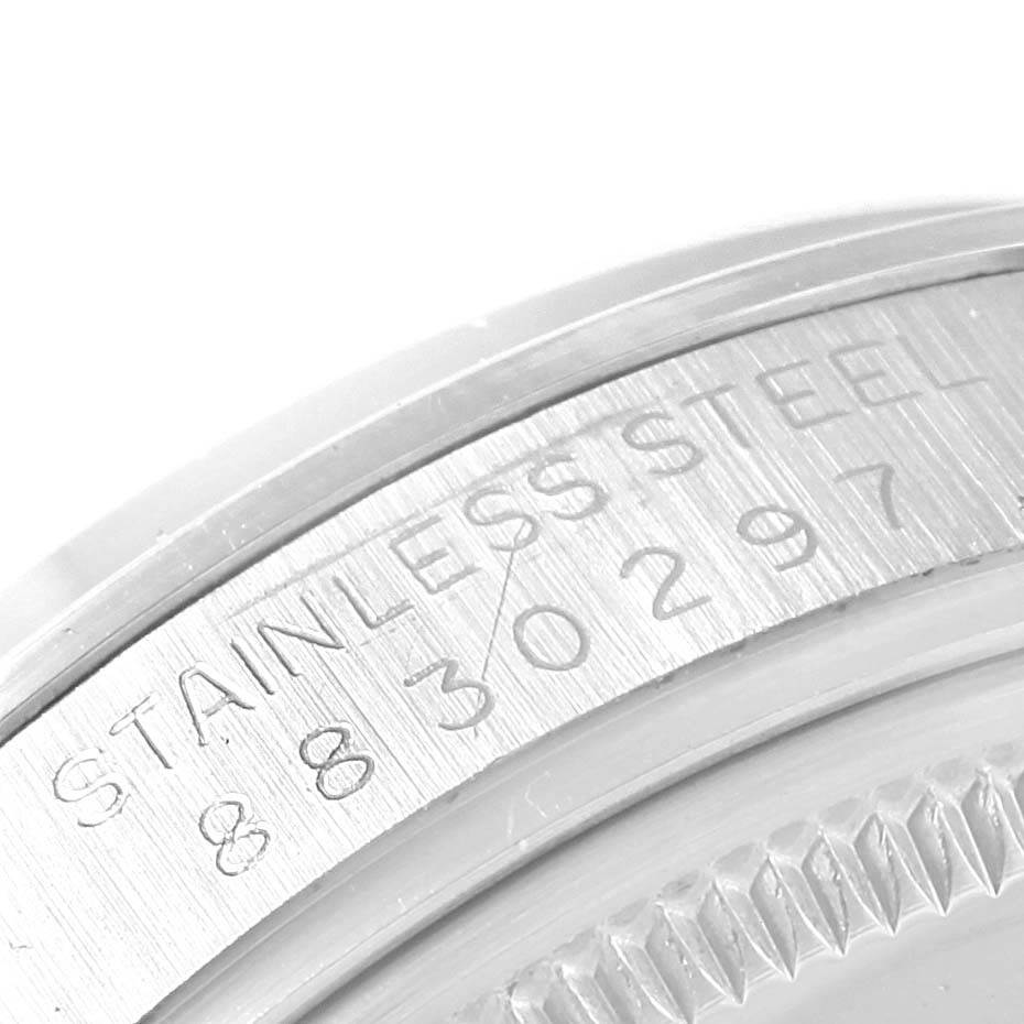 The image shows a close-up of the engraved stainless steel back casing and serial number of the Rolex Vintage Collection 15000 Men's Stainless Steel Silver Dial 15000 Men's Stainless Steel Silver Dial watch.