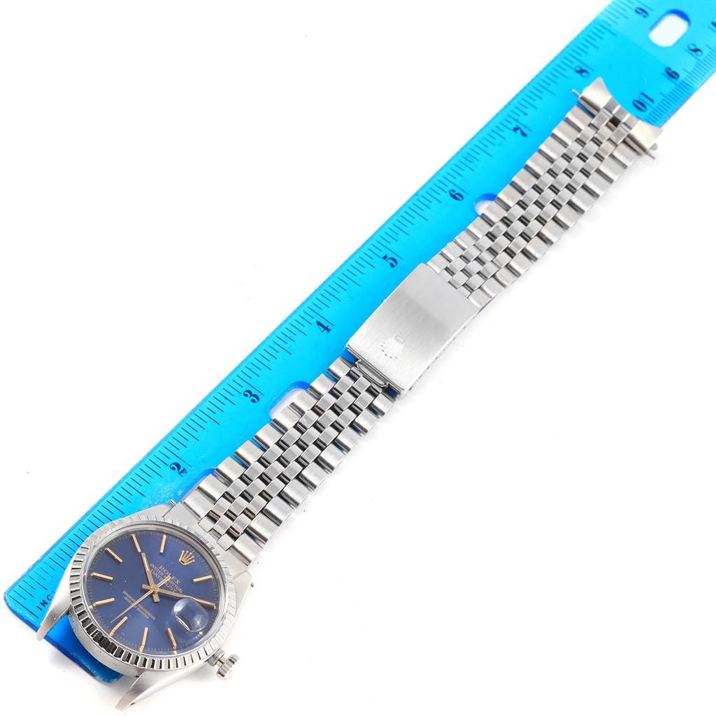 The Rolex Vintage Collection 16030 Men's Stainless Steel Blue Dial 16030 Men's Stainless Steel Blue Dial watch is shown flat from above with a blue dial and jubilee bracelet next to a ruler.