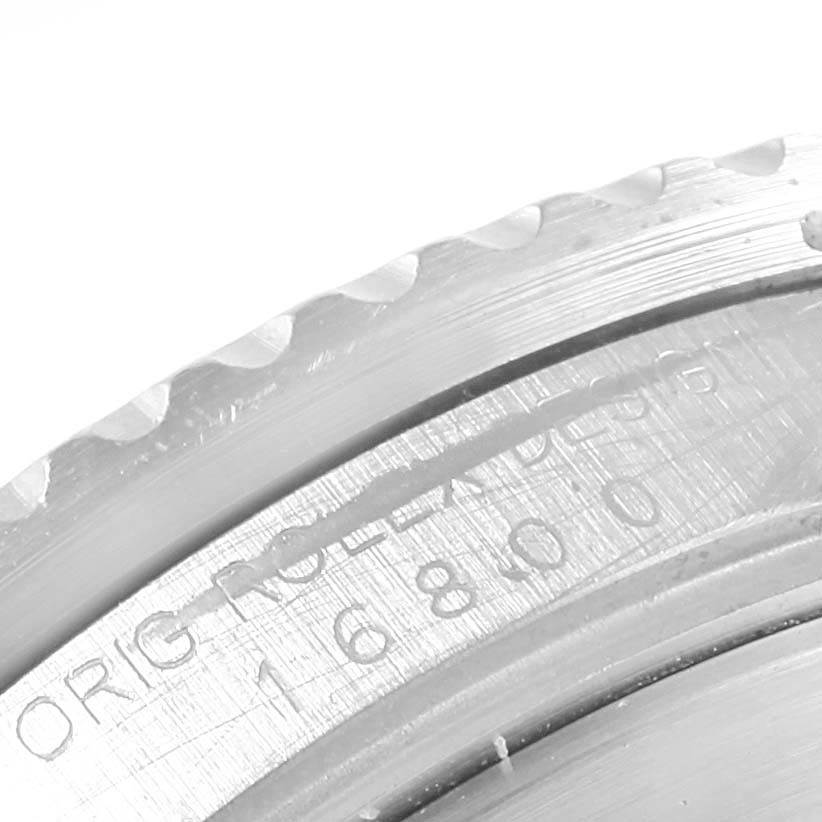 The image shows a close-up of the bezel and part of the case back engraving on a Rolex Vintage Collection 16800 Men's Stainless Steel Black Dial 16800 Men's Stainless Steel Black Dial model.