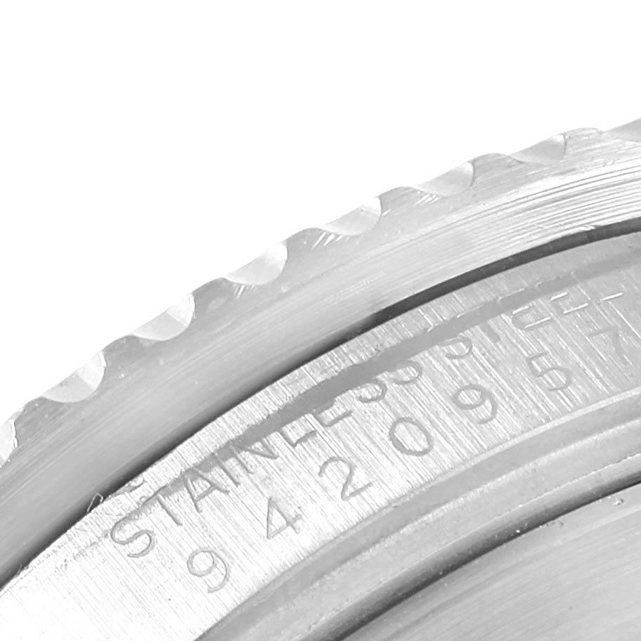 This close-up image shows the edge and engraving on the stainless steel bezel and part of the case of a Rolex Vintage Collection 16800 Men's Stainless Steel Black Dial 16800 Men's Stainless Steel Black Dial model watch.