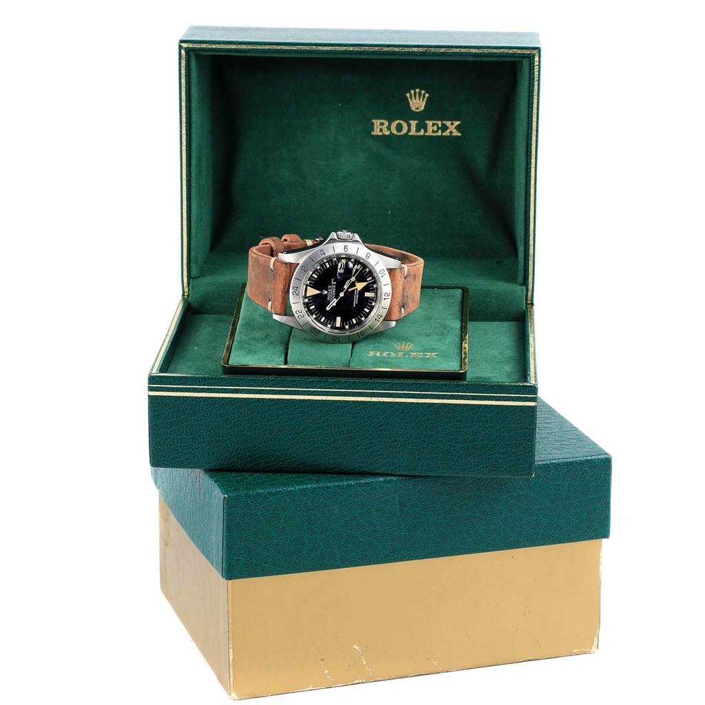 The Rolex Vintage Collection 1655 Men's Stainless Steel Black Dial 1655 Men's Stainless Steel Black Dial watch is shown at a front angle inside its green Rolex box with a brown leather strap visible.