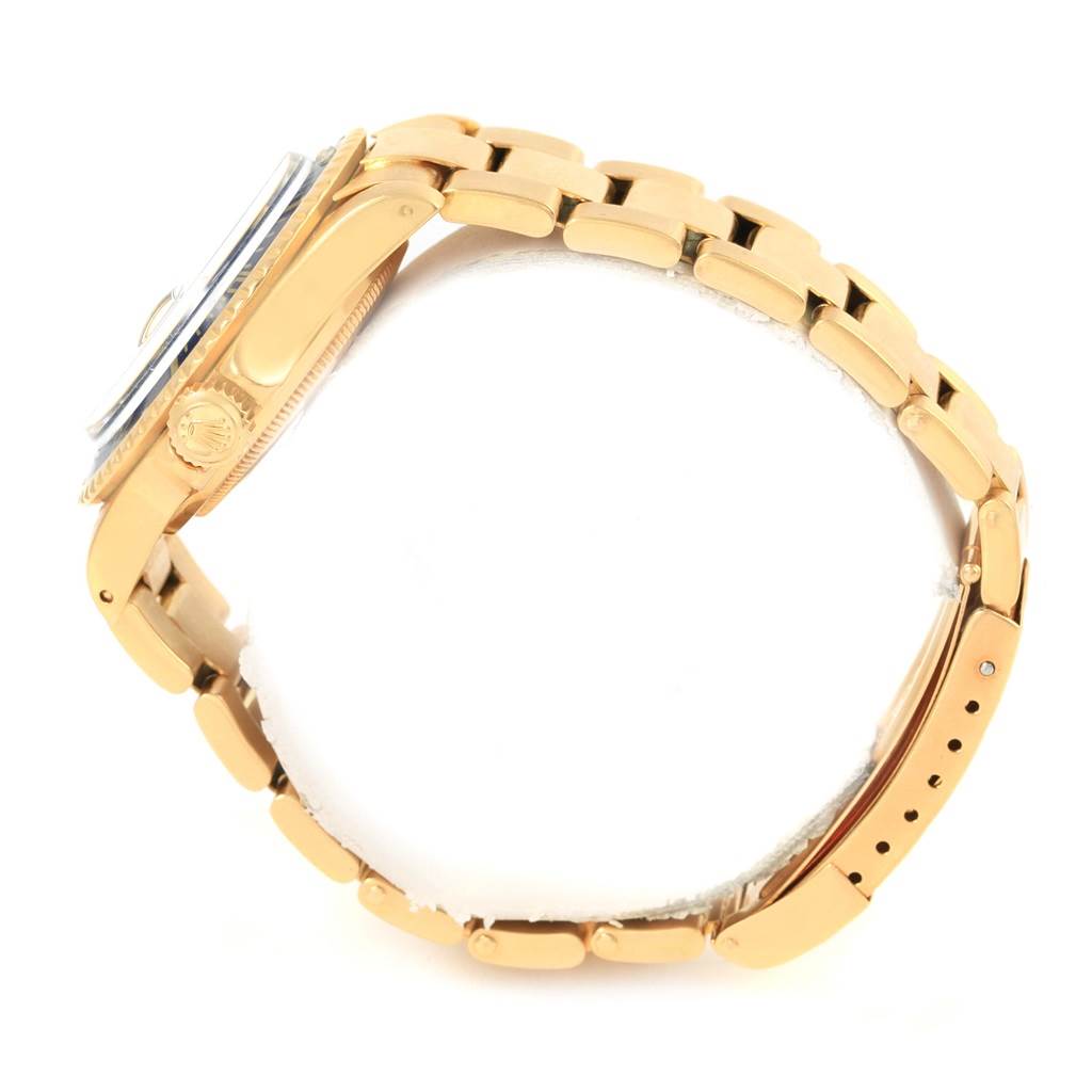 The image shows a side view of a Rolex Vintage Collection 1680 Men's Yellow Gold Blue Dial 1680 Men's Yellow Gold Blue Dial watch, highlighting its clasp and crown.